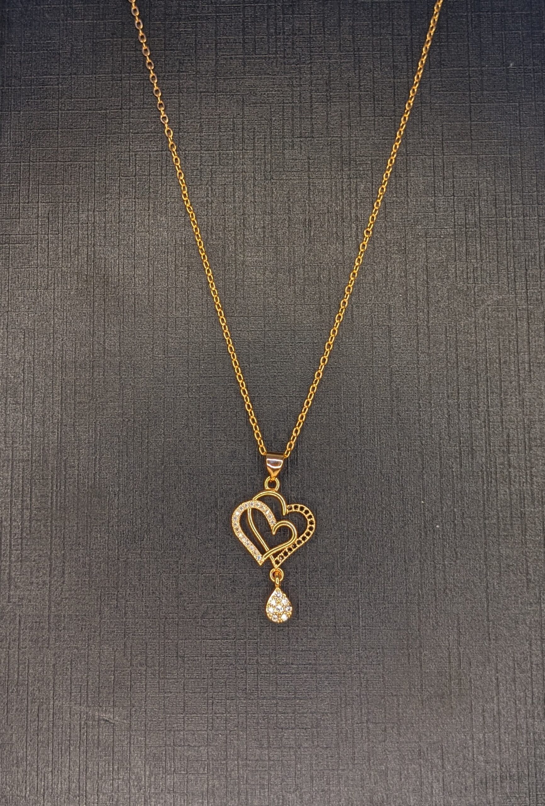 golden heart necklace with white stone